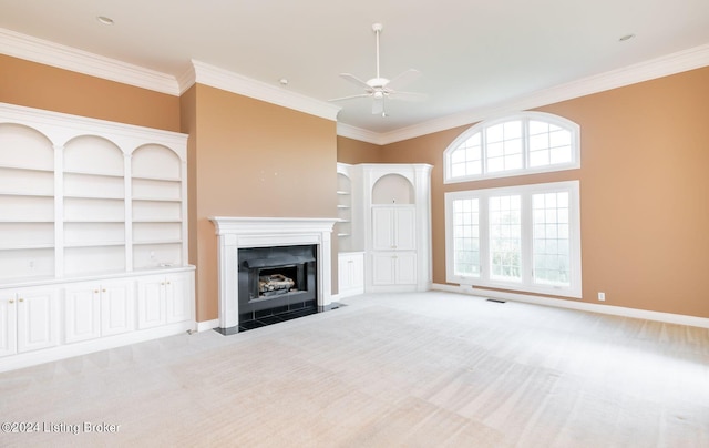 unfurnished living room featuring light carpet, ceiling fan, and crown molding