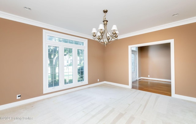 unfurnished room featuring carpet floors, an inviting chandelier, and ornamental molding