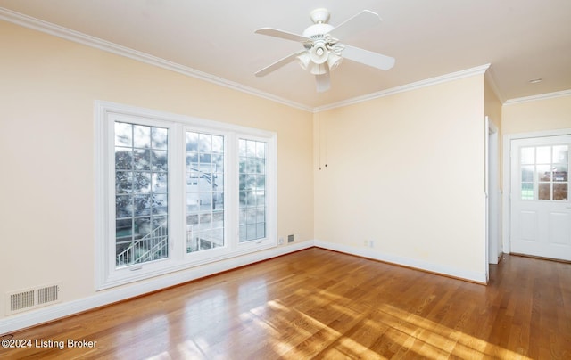 empty room featuring wood-type flooring, ceiling fan, and a wealth of natural light