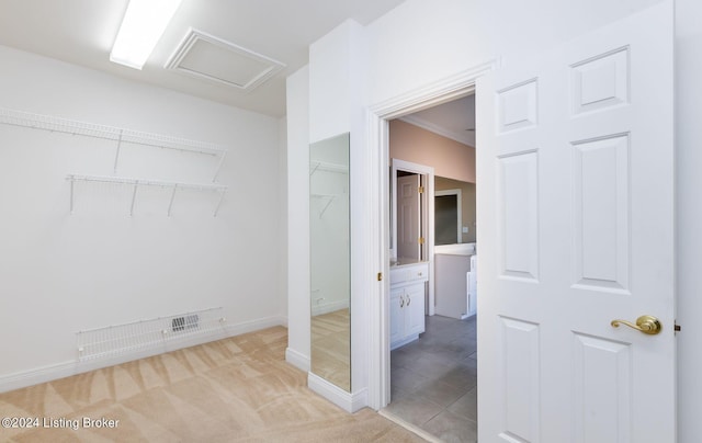 bathroom with ornamental molding and tile patterned floors