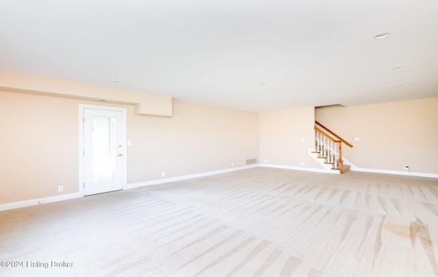 basement featuring light colored carpet