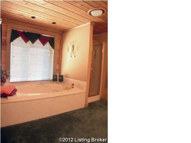 full bath featuring wood ceiling, a garden tub, and a shower stall