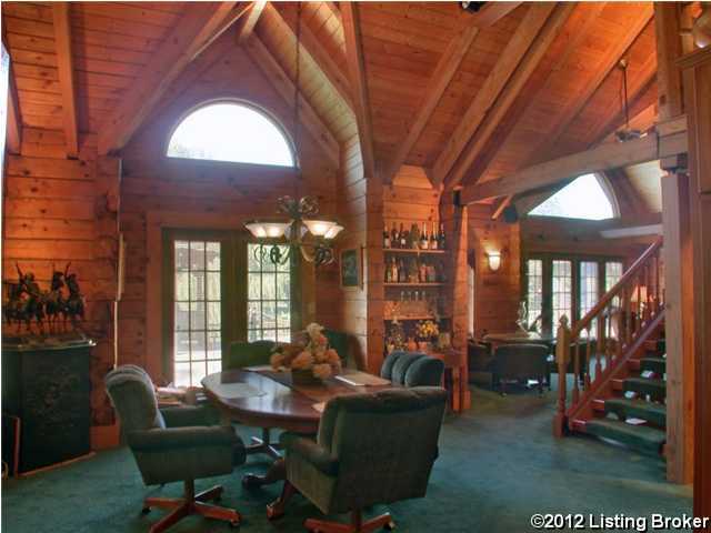 dining area featuring lofted ceiling with beams, wooden walls, carpet floors, an inviting chandelier, and wood ceiling