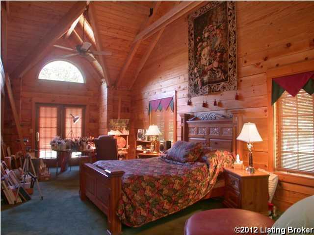 bedroom featuring multiple windows, wooden walls, and wooden ceiling