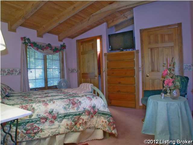 bedroom with wood ceiling, lofted ceiling with beams, and carpet flooring