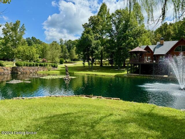 view of community with a water view and a yard