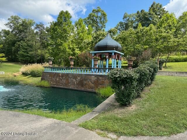 exterior space featuring a water view, a gazebo, and a yard