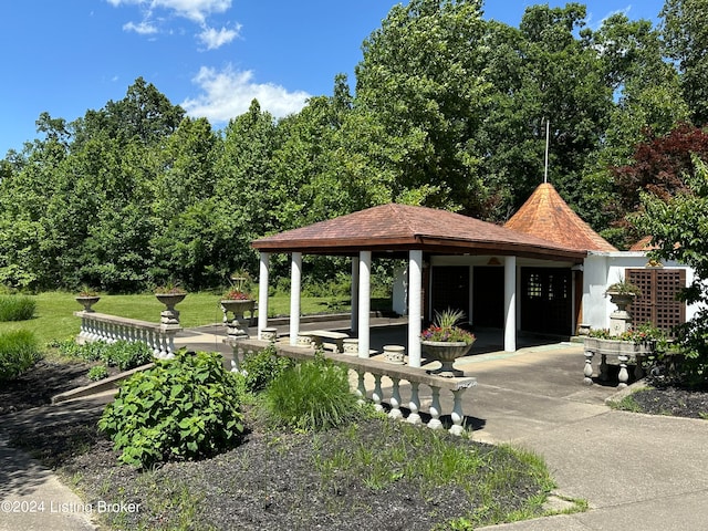 view of property's community with a gazebo, a yard, and a patio