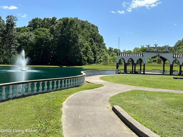 view of property's community featuring a water view and a yard