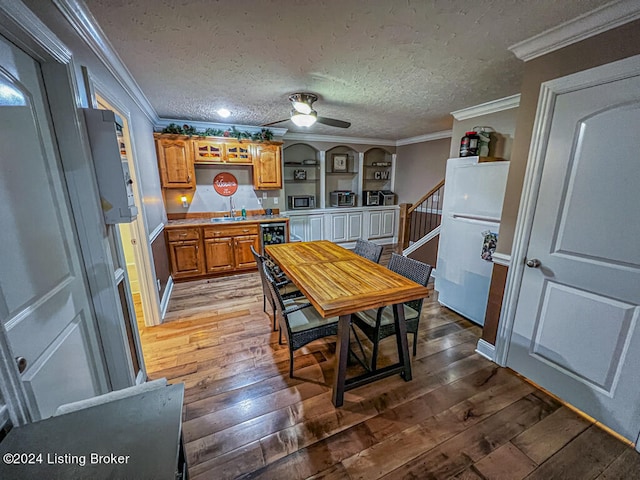 kitchen featuring ornamental molding, sink, and hardwood / wood-style flooring