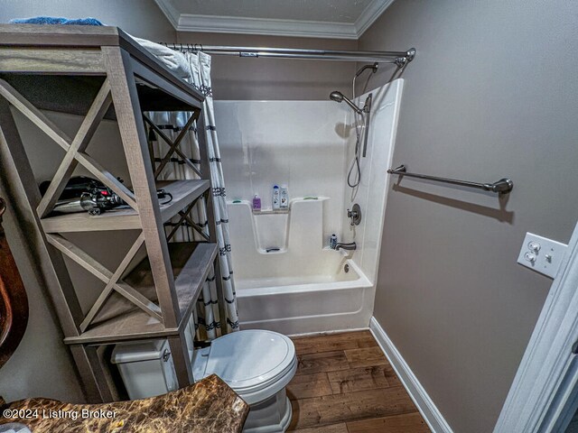 full bathroom featuring vanity, shower / bath combination with curtain, wood-type flooring, crown molding, and toilet