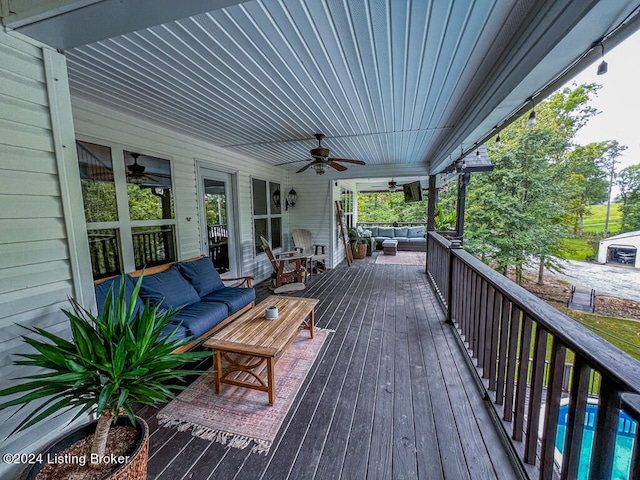 deck with ceiling fan, an outdoor hangout area, and a pool