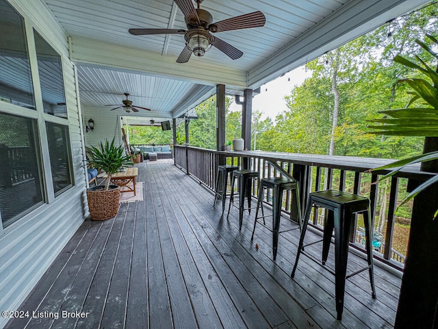 wooden deck featuring ceiling fan