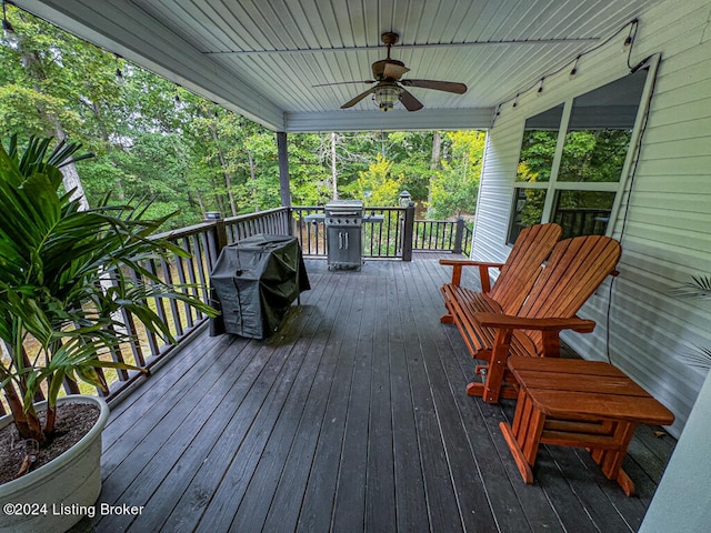 deck with grilling area and ceiling fan