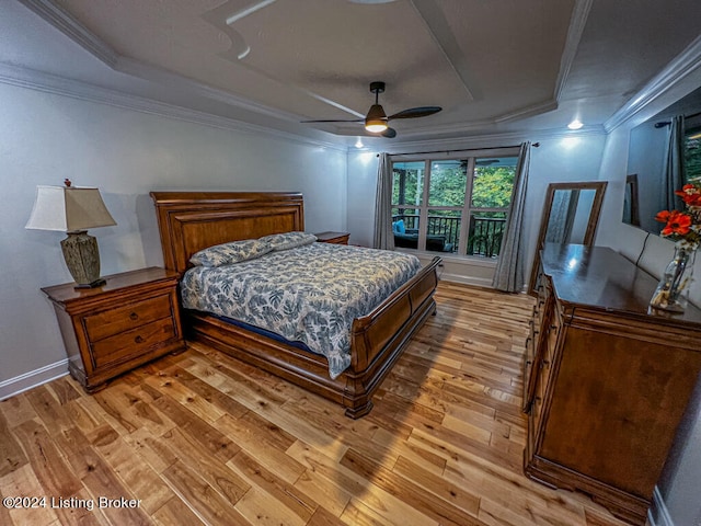 bedroom with ceiling fan, light hardwood / wood-style flooring, crown molding, and a raised ceiling