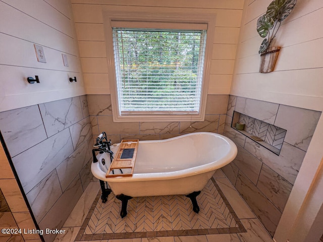 bathroom featuring tile walls and a bath