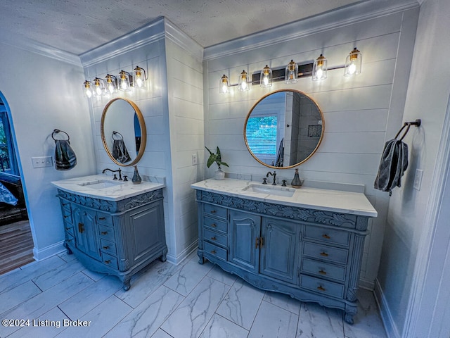 bathroom featuring vanity, ornamental molding, and a textured ceiling