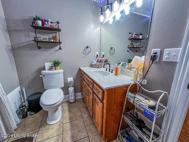 bathroom with vanity, toilet, and tile patterned floors