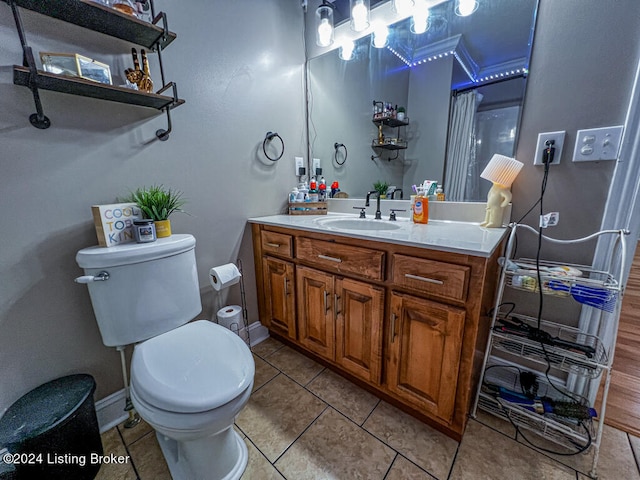 bathroom with tile patterned flooring, vanity, and toilet