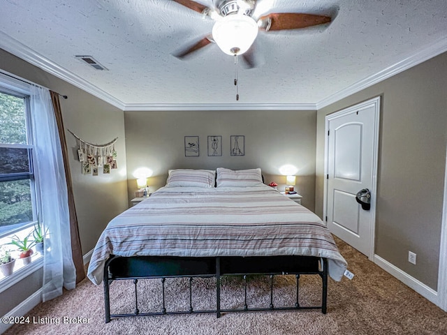 bedroom with ceiling fan, carpet floors, and ornamental molding