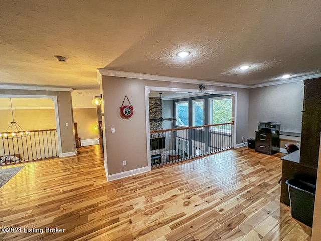 living room featuring a textured ceiling, crown molding, and hardwood / wood-style floors