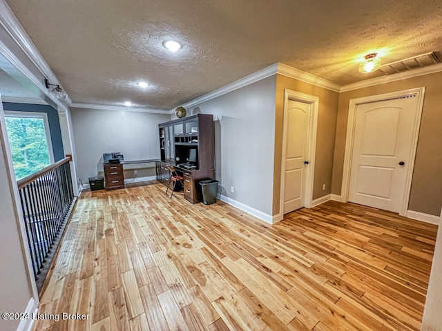 interior space featuring a textured ceiling, crown molding, and light hardwood / wood-style floors