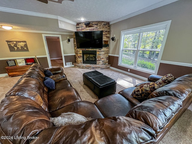 living room featuring carpet floors, a stone fireplace, and crown molding