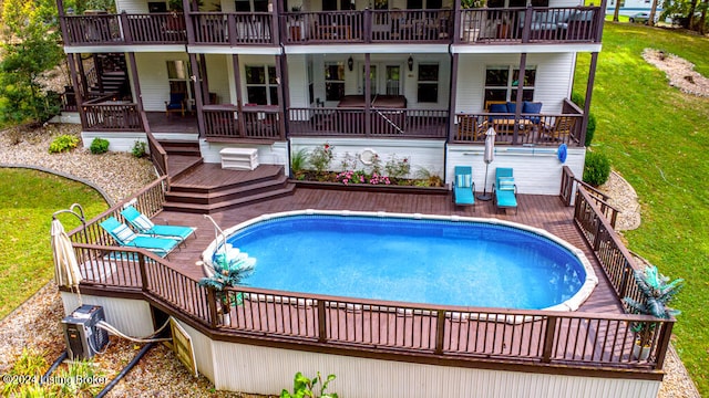 view of pool with a yard and a wooden deck