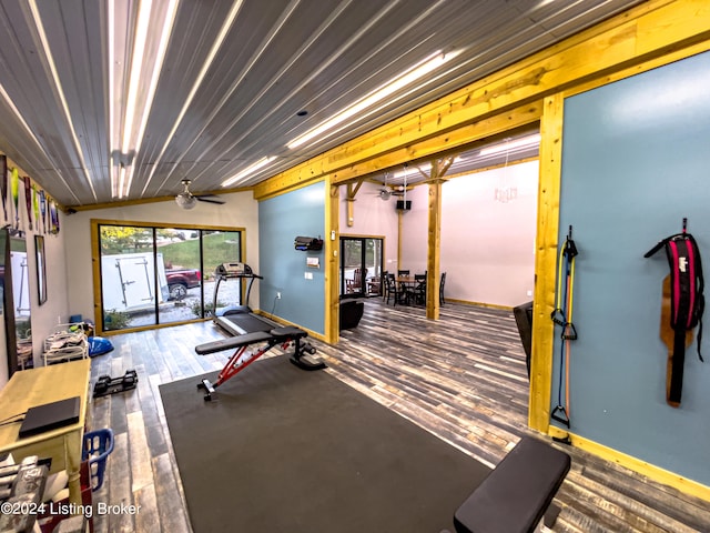 exercise area with wood-type flooring, lofted ceiling, and ceiling fan