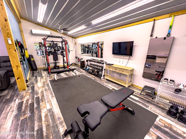 workout room featuring a wall mounted AC, vaulted ceiling, and ceiling fan