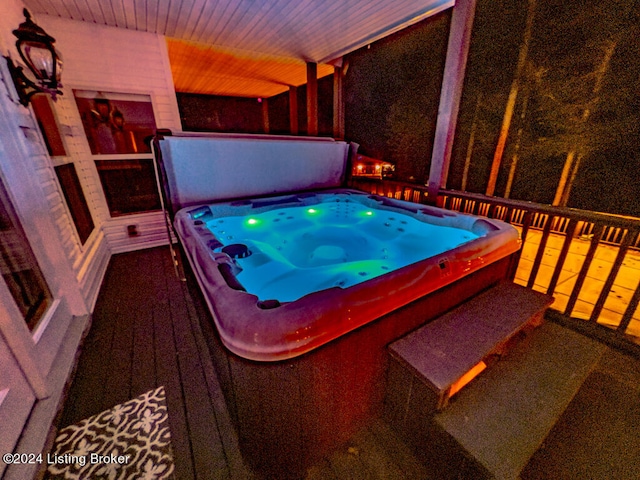 misc room featuring carpet floors, a hot tub, and wooden ceiling