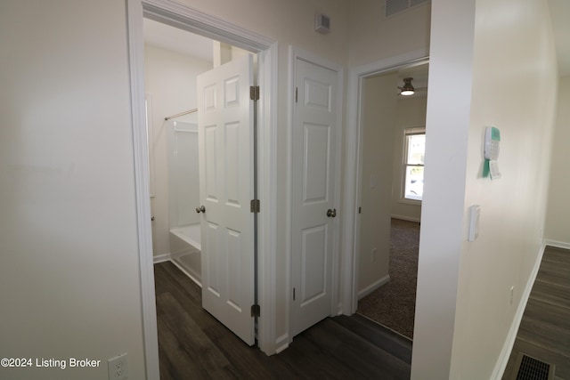 corridor with dark hardwood / wood-style flooring