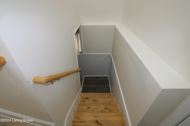 staircase with wood-type flooring