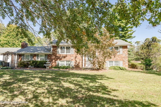 tri-level home with a front lawn