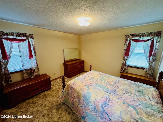 carpeted bedroom featuring a textured ceiling