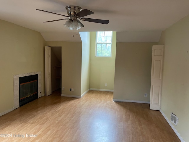 1406 Cardinal Dr, Louisville, KY 40213 - unfurnished living room featuring a premium fireplace, light hardwood / wood-style floors, ceiling fan, and vaulted ceiling
