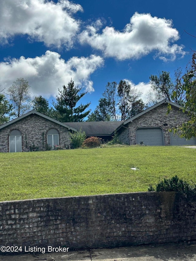 exterior space featuring a garage and a front lawn