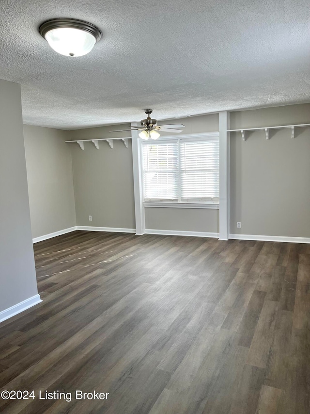 interior space with a textured ceiling, dark hardwood / wood-style flooring, and ceiling fan