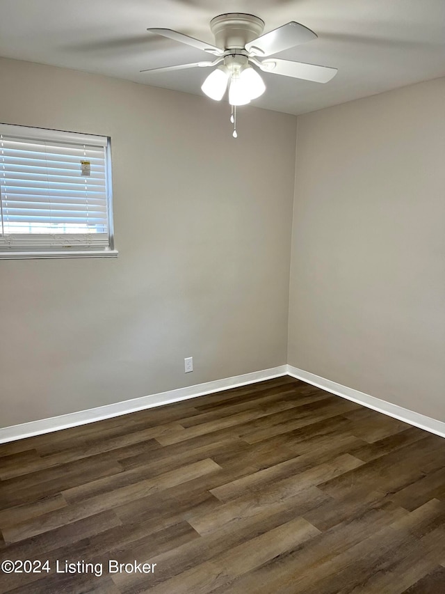 spare room featuring dark hardwood / wood-style floors and ceiling fan