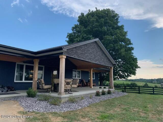 back of property featuring a yard and a patio area