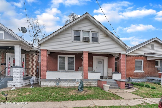 bungalow-style house with cooling unit and a porch