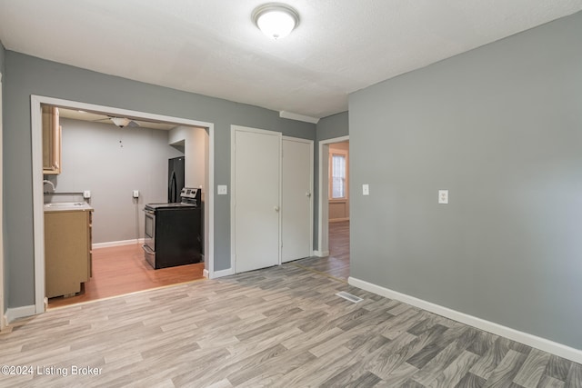 interior space featuring a textured ceiling and light hardwood / wood-style floors