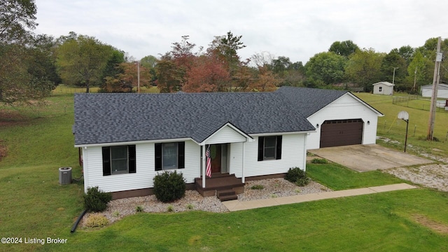 single story home with cooling unit, a front yard, and a garage