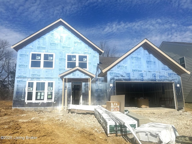 rear view of house with an attached garage