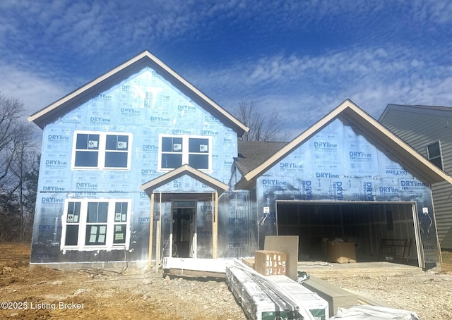 back of house featuring an attached garage