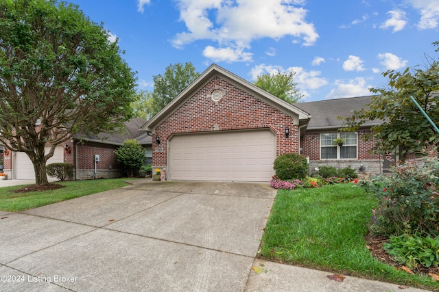 view of front of home with a front lawn and a garage