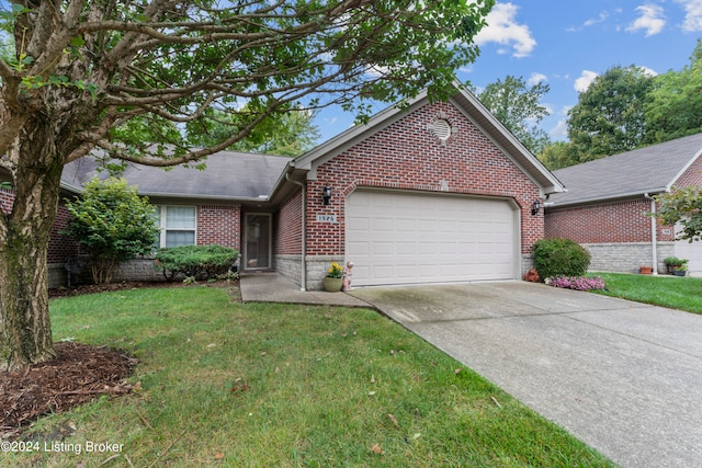 ranch-style home featuring a front lawn and a garage