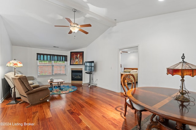 living room with ceiling fan, beam ceiling, wood-type flooring, and high vaulted ceiling