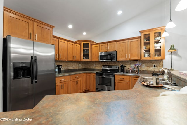 kitchen featuring pendant lighting, sink, vaulted ceiling, decorative backsplash, and appliances with stainless steel finishes