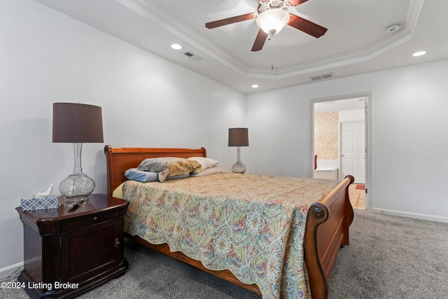 bedroom featuring ceiling fan, a tray ceiling, crown molding, and carpet